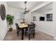 This dining area features stylish chairs, an elegant table setting, and a unique, modern light fixture overhead at 15446 Coopers Hawk Way, Parker, CO 80134