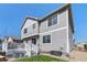 Back of home featuring a deck with stairs, a small lawn, and modern siding, showcasing outdoor living space at 15446 Coopers Hawk Way, Parker, CO 80134