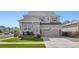 Charming two-story home with a well-maintained lawn and inviting front porch at 15446 Coopers Hawk Way, Parker, CO 80134
