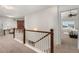 Hallway featuring the stairway, a barn door entrance and another room with a window at 15446 Coopers Hawk Way, Parker, CO 80134
