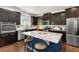Stylish kitchen with an island, granite countertops, stainless steel appliances, and ample cabinetry at 15446 Coopers Hawk Way, Parker, CO 80134