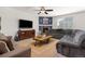 Comfortable living room featuring a cozy fireplace, plush seating, and abundant natural light at 15446 Coopers Hawk Way, Parker, CO 80134