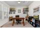 Bright office space with trophy shelves and a view out the window at 15446 Coopers Hawk Way, Parker, CO 80134