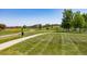 A well manicured park with walking trails and mature trees provides a serene escape for residents at 15446 Coopers Hawk Way, Parker, CO 80134