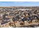 Panoramic aerial view of a residential community with modern homes, snow-dusted yards, and scenic open space at 4565 Colorado River Dr, Firestone, CO 80504