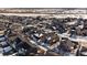 High-angle aerial view showcasing a densely populated residential community with varied home styles and snow-covered landscapes at 4565 Colorado River Dr, Firestone, CO 80504