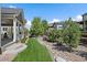 View of the backyard with beautifully trimmed lawn at 4565 Colorado River Dr, Firestone, CO 80504