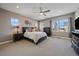 Large bedroom with windows, ceiling fan, and neutral decor at 4565 Colorado River Dr, Firestone, CO 80504