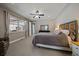Bright bedroom featuring a large window, ceiling fan, and neutral decor at 4565 Colorado River Dr, Firestone, CO 80504