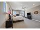 Bright bedroom with windows, ceiling fan, dresser, and neutral decor at 4565 Colorado River Dr, Firestone, CO 80504