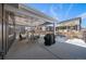 Inviting covered patio with grill, dining set, and views of the fenced yard, perfect for outdoor entertaining at 4565 Colorado River Dr, Firestone, CO 80504