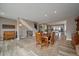 Open-concept dining room featuring wood floors and seamless transition to the kitchen and living area at 4565 Colorado River Dr, Firestone, CO 80504