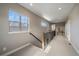 Upstairs hallway with carpet, windows, and railing at 4565 Colorado River Dr, Firestone, CO 80504