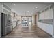 Bright kitchen with stainless steel appliances, island, and ample cabinet space at 4565 Colorado River Dr, Firestone, CO 80504