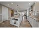 Bright, open kitchen features stainless steel appliances, granite counters, and a large central island with shelving at 4565 Colorado River Dr, Firestone, CO 80504