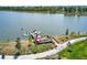 Aerial lake view featuring a boardwalk, kayaks, and lush landscaping, showcasing lakeside recreational amenities at 4565 Colorado River Dr, Firestone, CO 80504