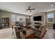 Cozy living room with a stone fireplace, comfortable seating, and wood floors at 4565 Colorado River Dr, Firestone, CO 80504