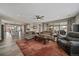Open-concept living room with wood floors, comfortable seating, and access to the outdoor patio area at 4565 Colorado River Dr, Firestone, CO 80504