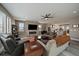 Bright living room with a stone fireplace, wood floors, and access to the kitchen area at 4565 Colorado River Dr, Firestone, CO 80504