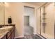 Modern bathroom showcasing a sleek vanity, tiled flooring, and a glass-enclosed shower for a spa-like experience at 4807 River Highlands Loop, Elizabeth, CO 80107