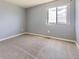 A bright bedroom featuring neutral tones, carpeted floor, and a window with a view at 4807 River Highlands Loop, Elizabeth, CO 80107
