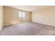 Spacious carpeted bedroom with a large window offering natural light and neighborhood views at 4807 River Highlands Loop, Elizabeth, CO 80107