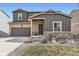 Exterior view of a home featuring a two-car garage and a well maintained front yard at 4807 River Highlands Loop, Elizabeth, CO 80107