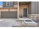 The front entrance has neutral colors and a two-car garage, offering an inviting facade and convenience at 4807 River Highlands Loop, Elizabeth, CO 80107