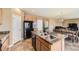 Open-concept kitchen with an island, seamlessly connecting to the dining and living area, creating a social hub at 4807 River Highlands Loop, Elizabeth, CO 80107
