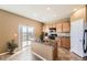 Bright kitchen featuring modern appliances, a functional island, and a sliding glass door to the backyard at 4807 River Highlands Loop, Elizabeth, CO 80107