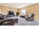 Neutral Living Room with window providing natural light, complemented by a comfortable couch, ottoman, and plants at 4807 River Highlands Loop, Elizabeth, CO 80107