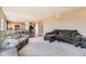 Large living room showcasing an open floor plan with dining area and neutral color palette at 4807 River Highlands Loop, Elizabeth, CO 80107