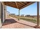 Covered brick patio and a view of the property's backyard and surrounding neighborhood at 4807 River Highlands Loop, Elizabeth, CO 80107