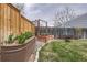 Backyard featuring planter boxes with a rock border and grass at 8985 W Quarto Pl, Littleton, CO 80128
