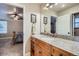 Bathroom featuring a granite countertop vanity with a door that opens into a bedroom at 8985 W Quarto Pl, Littleton, CO 80128