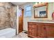 Bathroom featuring a tub with tile surround and custom cabinet and countertop at 8985 W Quarto Pl, Littleton, CO 80128