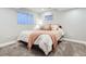Cozy bedroom with plush carpeting, neutral walls, and a window offering natural light at 8985 W Quarto Pl, Littleton, CO 80128