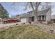 Charming two-story home with brick accents, rock landscaping, mature tree and an attached two-car garage at 8985 W Quarto Pl, Littleton, CO 80128