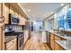 Spacious kitchen with stainless steel appliances, granite countertops, and a hardwood floor at 8985 W Quarto Pl, Littleton, CO 80128