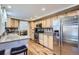 Modern kitchen featuring stainless steel appliances, granite countertops, and hardwood flooring at 8985 W Quarto Pl, Littleton, CO 80128