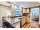 Well-lit kitchen featuring granite countertops, stainless steel sink, and hardwood floors at 8985 W Quarto Pl, Littleton, CO 80128