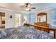 Comfortable bedroom featuring a ceiling fan, dresser and private ensuite bathroom for added convenience at 8985 W Quarto Pl, Littleton, CO 80128