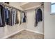 Spacious walk-in closet with ample shelving and hanging space for organized storage at 8985 W Quarto Pl, Littleton, CO 80128
