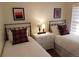 Well-lit bedroom showcasing twin beds, decorative pillows, and framed artwork above at 1805 W 34Th Ave, Denver, CO 80211