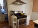 A kitchen is seen with stainless steel appliances, a subway tile backsplash, and a stained-glass window at 1805 W 34Th Ave, Denver, CO 80211