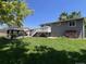 Expansive backyard with a gazebo, large lawn, and a quaint back deck leading from the home at 12235 Garfield Pl, Thornton, CO 80241