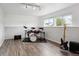 Finished basement featuring hardwood floors, a drum kit, and electric guitar at 12235 Garfield Pl, Thornton, CO 80241