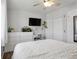 Minimalist bedroom featuring a ceiling fan, wood floors, dresser, and closet at 12235 Garfield Pl, Thornton, CO 80241