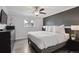 Spacious bedroom with wood floors, a ceiling fan, and modern decor at 12235 Garfield Pl, Thornton, CO 80241