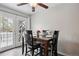 Cozy dining area with hardwood floors, white french doors, and a dark wood table set for four at 12235 Garfield Pl, Thornton, CO 80241